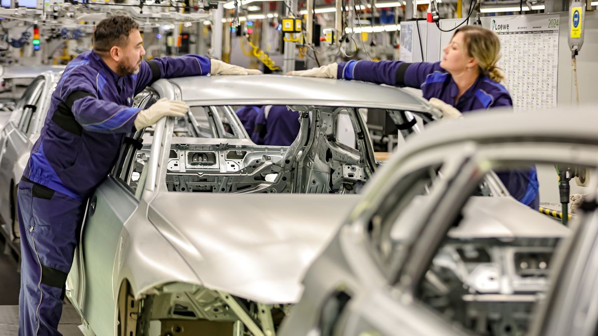MUNICH, GERMANY - DECEMBER 05: Members of BMW's manufacturing staff inspect a vehicle's finish as they work at the body shop finish during German Chancellor Olaf Scholz visits the BMW Group car factory on December 05, 2023 in Munich, Germany. His visit is taking place as Scholz's government wrestles with a federal budget crisis stemming from a recent Federal Constitutional Court ruling. (Photo by Leonhard Simon/Getty Images)