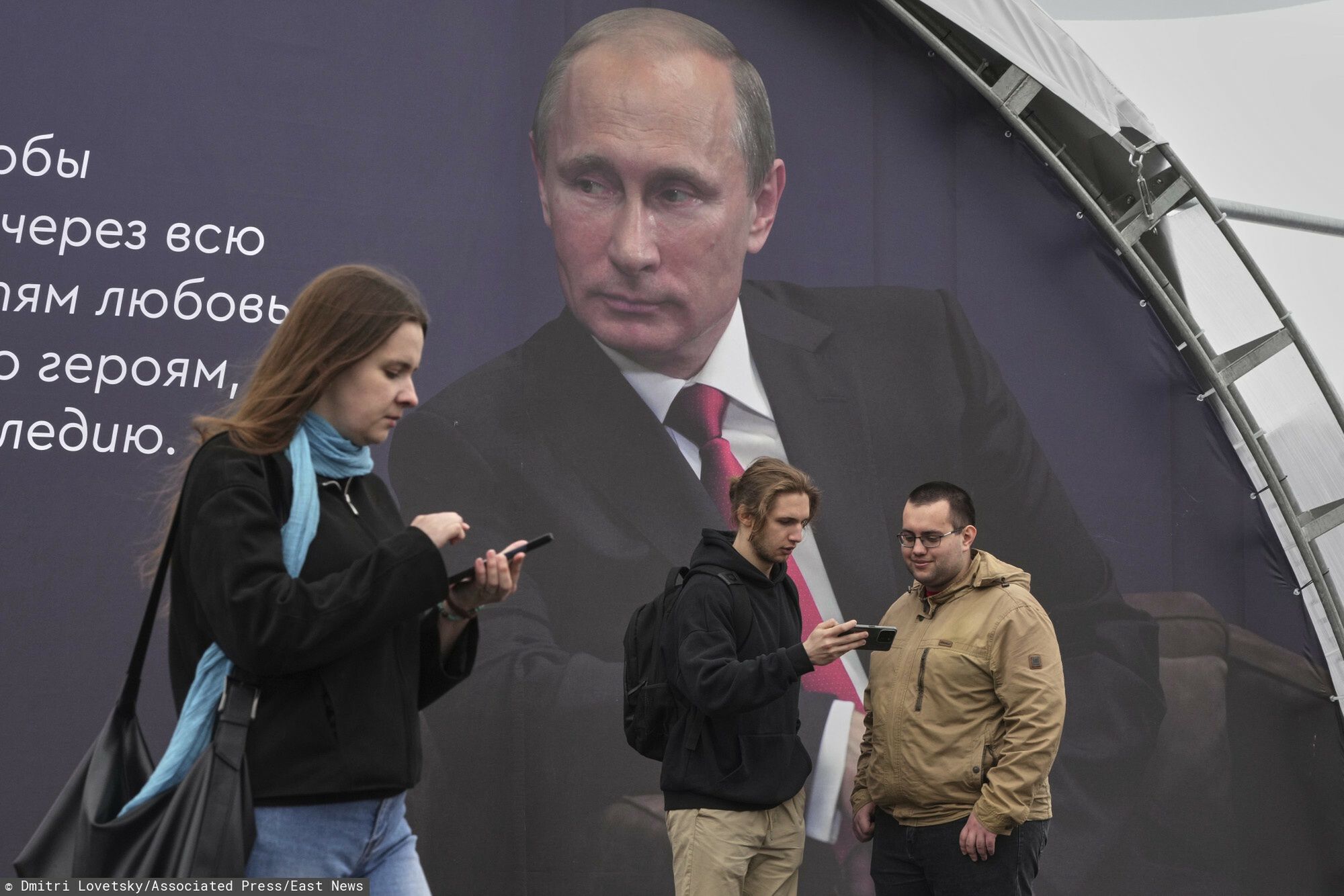 Temporary
People stand next to a poster with an image of Russian President Vladimir Putin and a quote from his message at an annual book festival in St. Petersburg, Russia, Thursday, May 22, 2025. (AP Photo/Dmitri Lovetsky)
Dmitri Lovetsky