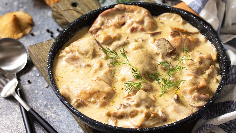 Fricasse - French Cuisine. Chicken stewed in a creamy sauce with mushrooms in a pan on a light stone background. fricasse, chicken, champignon, filet, grill, culinary, red mushroom, cuisine, frying, homemade, bechamel, mustard, morning sauce, healthy, white sauce, turkey, lunch, meal, cream, meat, dish, meal, dinner, cuisine, french cooking, stew, poultry, vegetable, sauce, recipe, stew, wooden, closeup, homemade, green, garlic, table, mushroom, eat, seasonings, rustic, vegetables, hot, frying pan, thanksgiving, table menu, stroganoff