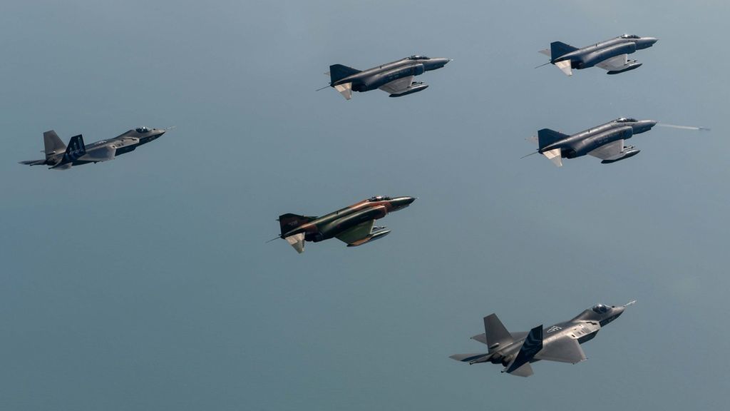 Two KF-21 in flight with F-4 Phantom II aircraft