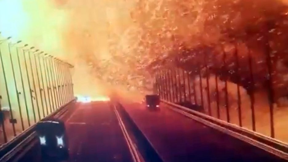 CRIMEA - OCTOBER 08: A screen grab from a surveillance footage shows flames and smoke rising up after an explosion at the Kerch bridge in the Kerch Strait, Crimea, October 8, 2022. A bridge connecting Crimea to Russia caught fire early Saturday morning causing suspension of traffic as all train services to Crimea temporarily suspended. The Kerch Bridge -- a pair of parallel bridges, one road and one railroad -- is a key supply route for Russia which was built after Crimea's annexation in 2014. (Photo by Security Camera/Anadolu Agency via Getty Images)