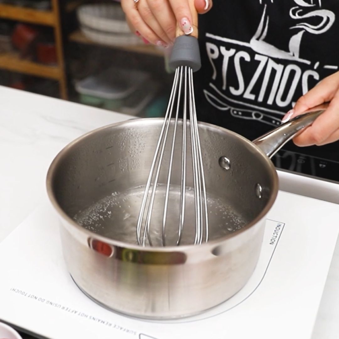 I combine the ingredients in the pot using a kitchen whisk.