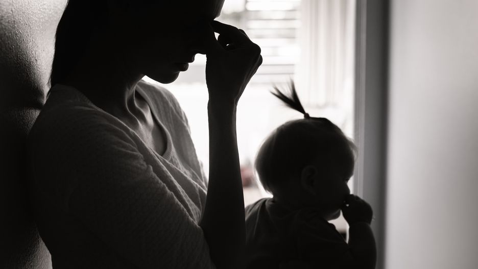 Tired mother taking care of babyMother is taking care of baby girl.kieferpix