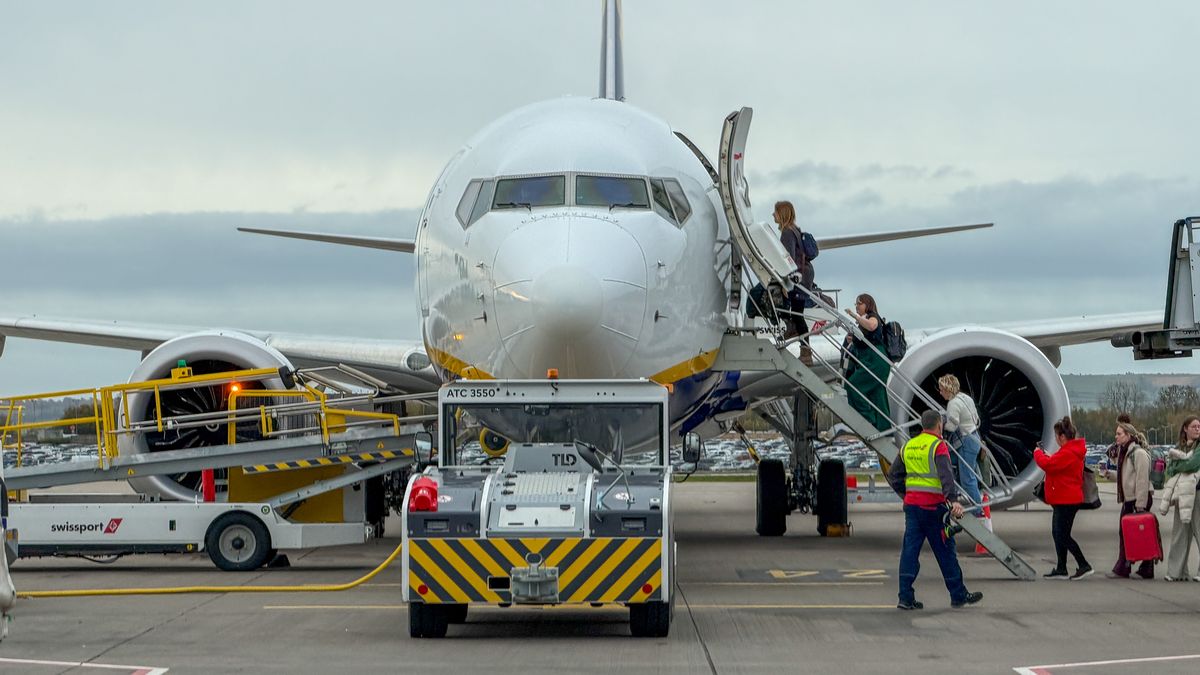 BRISTOL, UNITED KINGDOM - OCTOBER 30: Passengers board a Ryanair aircraft that is parked on the runaway at Bristol Airport, on October 30, 2025 in Bristol, England. With projections for passenger traffic to more than double by 2050, aviation carbon emissions are projected to increase, especially in relation to other sectors as their emissions decline. Global commitments to reducing future Co2 carbon emissions will mean a huge investment is needed in green and renewable energy sources and infrastructure such as solar and wind farms so that economies can transition from getting energy from carbon and fossil fuels to that generated by clean sources. (Photo by Matt Cardy/Getty Images)
