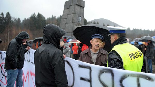Grupa osób pikietujących przed pomnikiem generała broni Karola Świerczewskiego w Jabłonkach w Bieszczadach