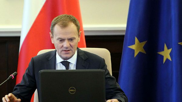 Premier Donald Tusk wpatrzony w komputer