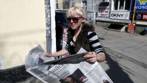 Kobieta czyta w Symferopolu rosyjską gazetę