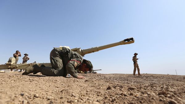 Kurdyjski bojownik modli się na polu walki w Iraku