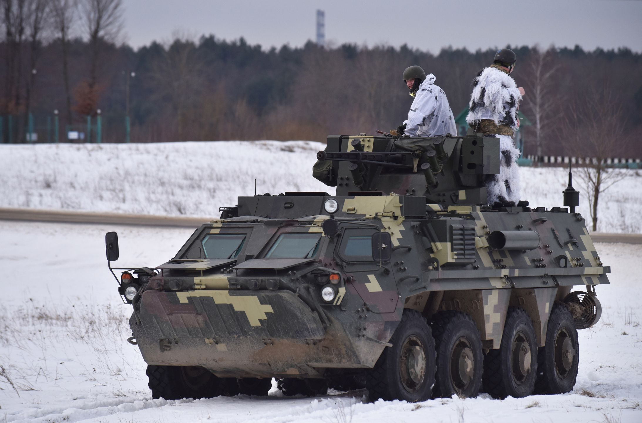 LVIV, UKRAINE - 2022/02/04: Ukrainian soldiers ride on top of the BTR-4 "Bucephalus" during the weapons training exercise.At the training ground at the International Center for Peacekeeping and Security of the National Academy of Land Forces named after Hetman Petro Sagaidachny, Ukrainian instructors are being trained in the use of M141 (or SMAW-D) grenade launchers recently transferred to Ukraine. The United States provided weapons to Ukraine because of a possible Russian attack. (Photo by Pavlo Palamarchuk/SOPA Images/LightRocket via Getty Images)