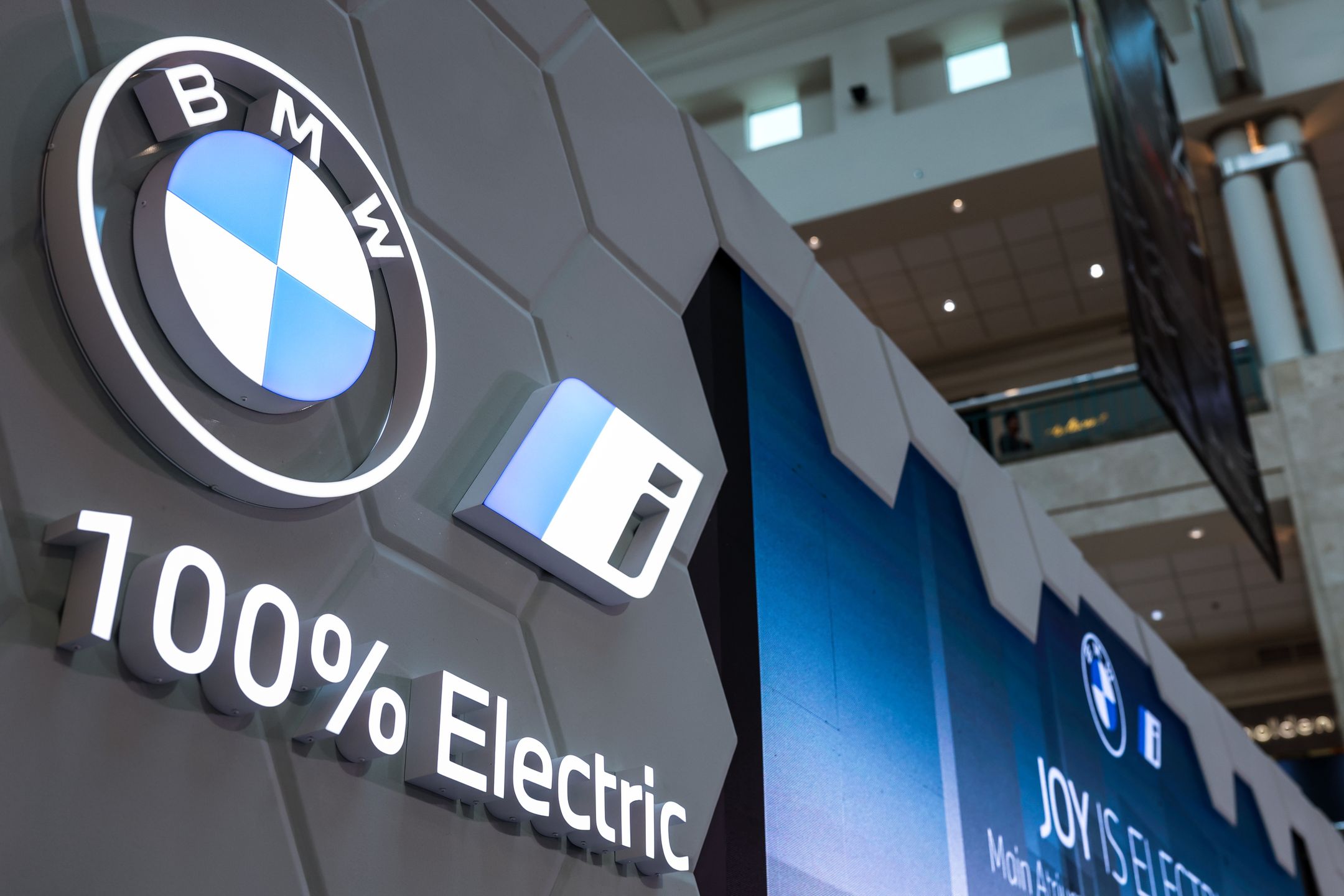 BMW's manufacturer logo is seen during the exhibition in Jakarta, Indonesia on November 1, 2023. The exhibition is dedicated to showcasing and promoting electric vehicles (EVs) powered by renewable energy sources. BMW is the leading premium brand in Indonesia in the first 6 months of 2023, registering a 28% increase over 2022. Furthermore, the BMW iX is also Indonesia's best-selling luxury Electric Vehicle. (Photo by Garry Lotulung/NurPhoto via Getty Images)