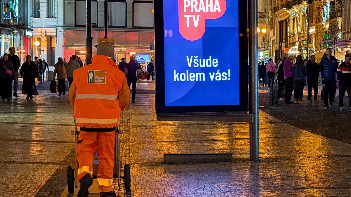 A municipal street cleaner from Prazske sluzby pushes a waste collection cart along a busy pedestrian street illuminated by city lights and digital signage in Prague, Czech Republic, on May 10, 2025. The city commits to urban cleanliness even in its most crowded areas through regular nighttime cleaning shifts. (Photo by Michael Nguyen/NurPhoto via Getty Images)