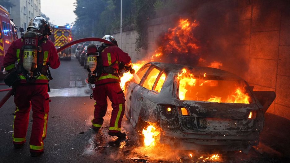 Temporary
Firefighters work to put out a burning car on the sidelines of a demonstration in Nanterre, west of Paris, on June 27, 2023, after French police killed a teenager who refused to stop for a traffic check in the city. The 17-year-old was in the Paris suburb early on June 27 when police shot him dead after he broke road rules and failed to stop, prosecutors said. The event has prompted expressions of shock and questions over the readiness of security forces to pull the trigger. (Photo by Zakaria ABDELKAFI / AFP)
ZAKARIA ABDELKAFI