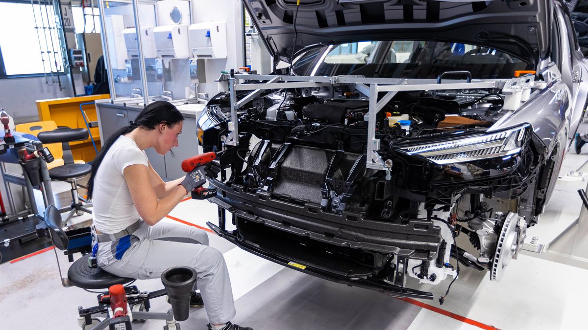 An employee works on the front grille of an Audi Q4 e-tron electric vehicle (EV) on the assembly line at the Volkswagen AG (VW) electric automobile plant in Zwickau, Germany, on Tuesday, April 26, 2022. The Zwickau assembly lines are the centerpiece of a plan by VW, the world's biggest automaker, to manufacture as many as 330,000 cars annually. Photographer: Krisztian Bocsi/Bloomberg via Getty Images
