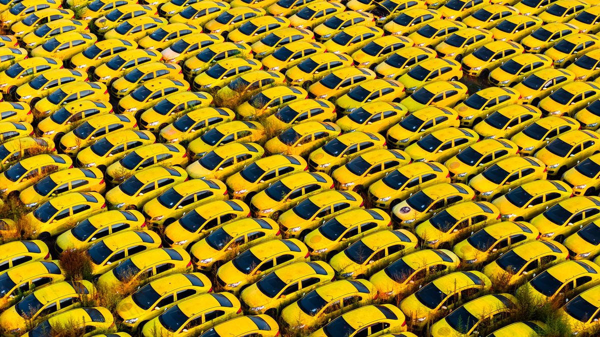 CHONGQING, CHINA - JULY 08: In an aerial view, yellow cars line up neatly at a scrap processing plant on July 8, 2026 in Chongqing, China. (Photo by Zhang Kunkun/VCG via Getty Images)