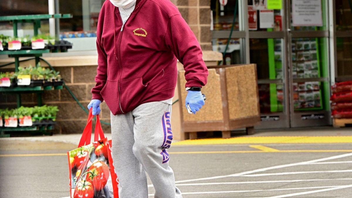 A shopper walks out of a Shoprite with groceries on Wednesday, May 6, 2020 in Colonie, N.Y. Shoprite is one of the local grocery stores limiting beef, pork and poultry sales. (Photo by Lori Van Buren/Albany Times Union via Getty Images)