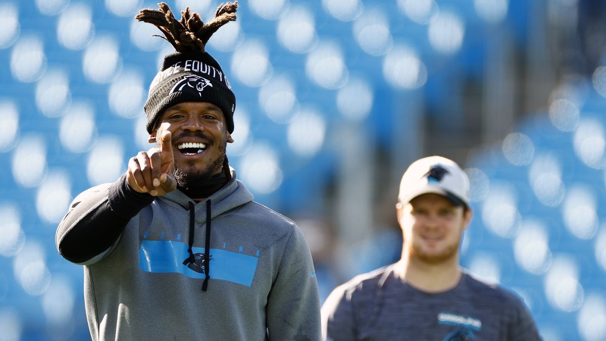 CHARLOTTE, NORTH CAROLINA - DECEMBER 26: Cam Newton #1 and Sam Darnold #14 of the Carolina Panthers look on prior to the first half of the game against the Tampa Bay Buccaneers at Bank of America Stadium on December 26, 2021 in Charlotte, North Carolina. (Photo by Jared C. Tilton/Getty Images)