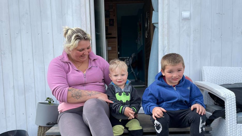 Angelika z dwoma synami przed swoim domem