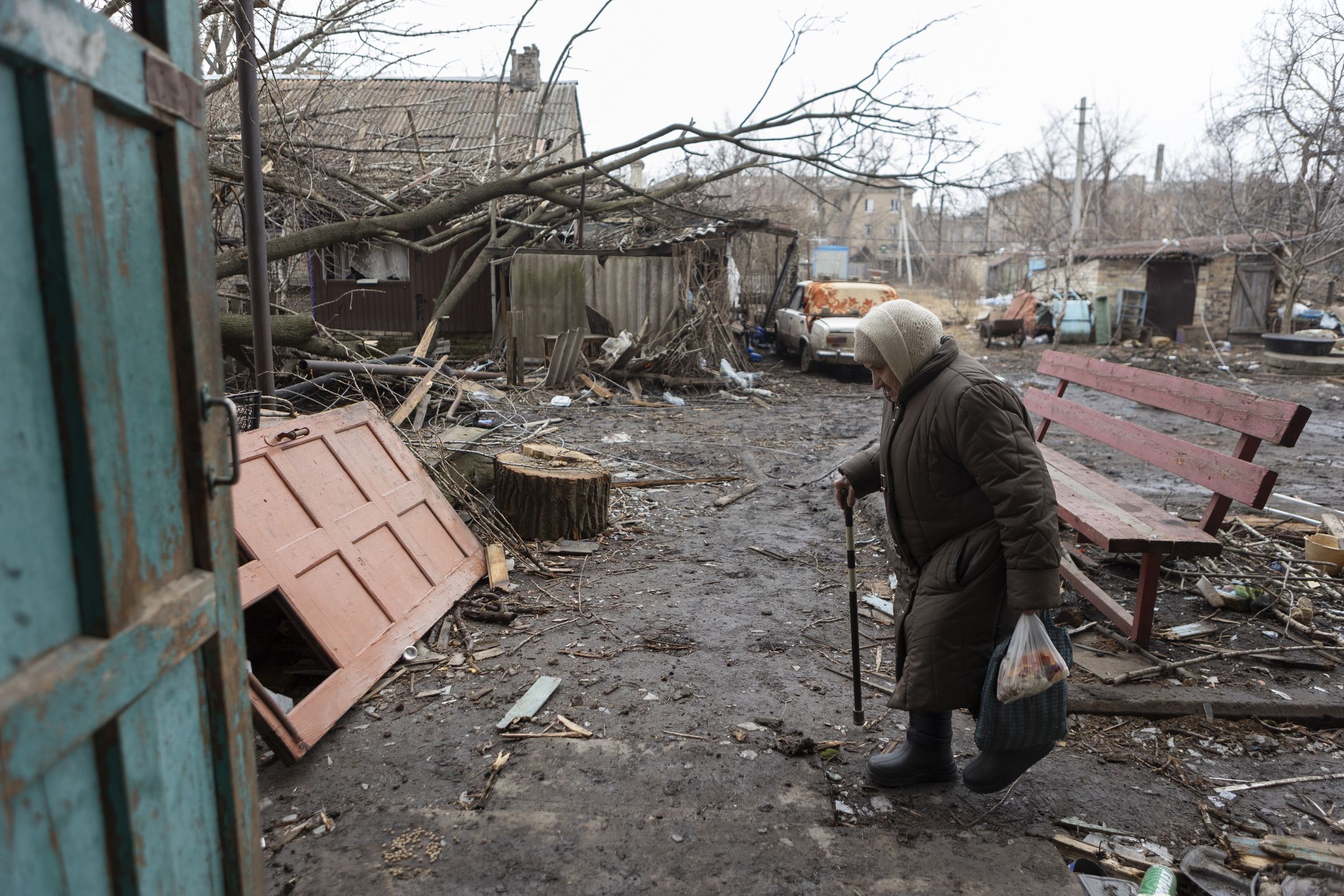 CHASIV YAR, UKRAINE - MARCH 16: An elderly woman walks amid debris at damaged residential district on March 16, 2024 in Chasiv Yar, Ukraine. After the occupation of Avdiivka, Russian troops focused on the offensive on Chasiv Yar, a town located west of Bakhmut. (Photo by Oleksandr Magula/Suspilne Ukraine/JSC "UA:PBC"/Global Images Ukraine via Getty Images)