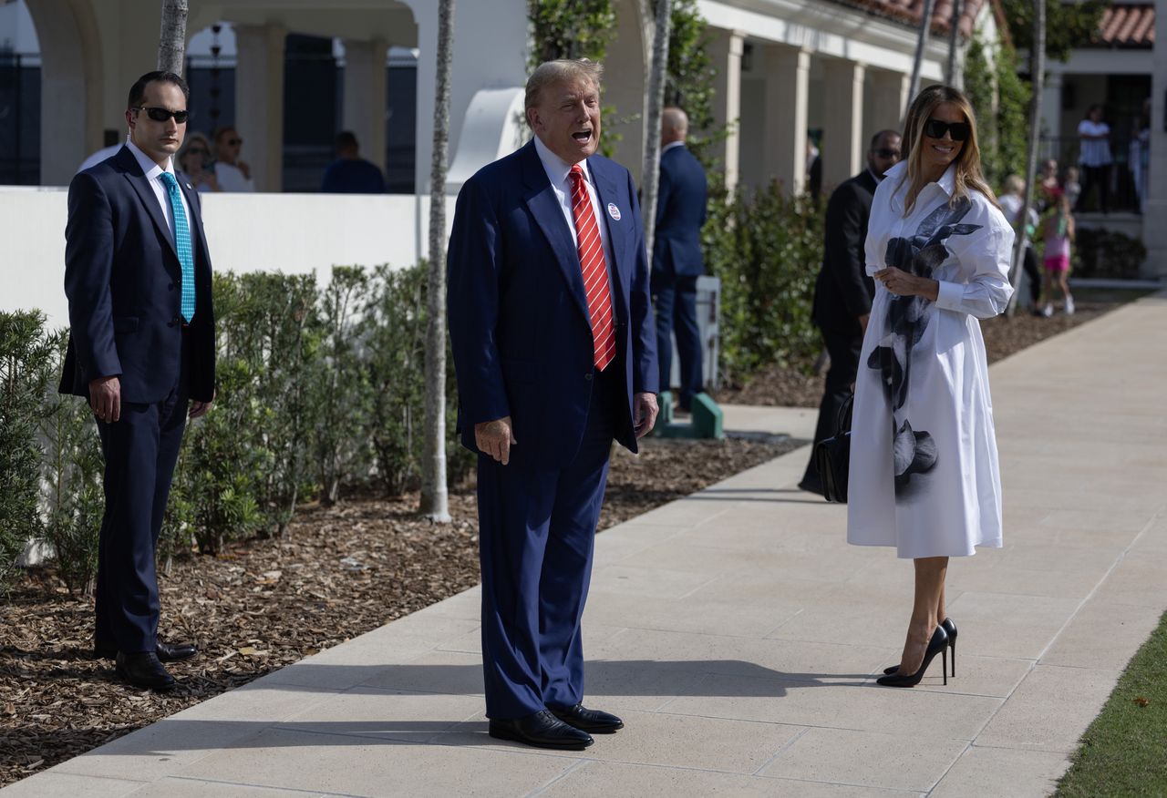 PALM BEACH, FLORIDA - MARCH 19:  Former U.S. President Donald Trump and former first lady Melania Trump stand together as he speaks with the media after voting at a polling station setup in the Morton and Barbara Mandel Recreation Center on March 19, 2024, in Palm Beach, Florida.  Trump, along with other registered Republican voters, cast ballots in the Presidential Preference Primary. There wasn't a ballot or election for Democrats since the Florida Democratic Party only provided the name of Joseph R. Biden Jr. (Photo by Joe Raedle/Getty Images)