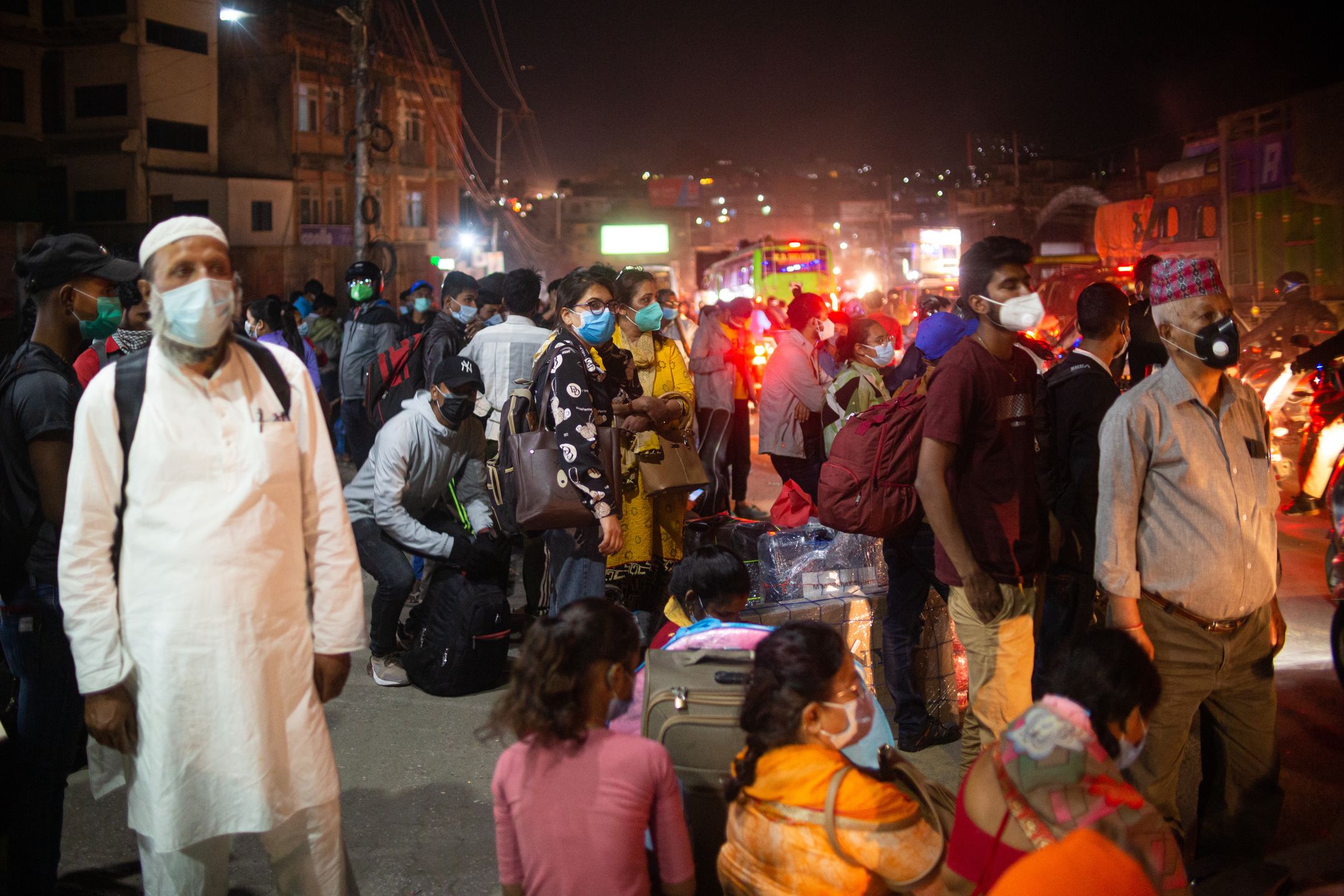 People wait to board a bus to head towards their villages after the government re-imposed restriction in Kathmandu valley from Thursday in Kathmandu, Nepal on April 27, 2021.   (Photo by Rojan Shrestha/NurPhoto via Getty Images)
