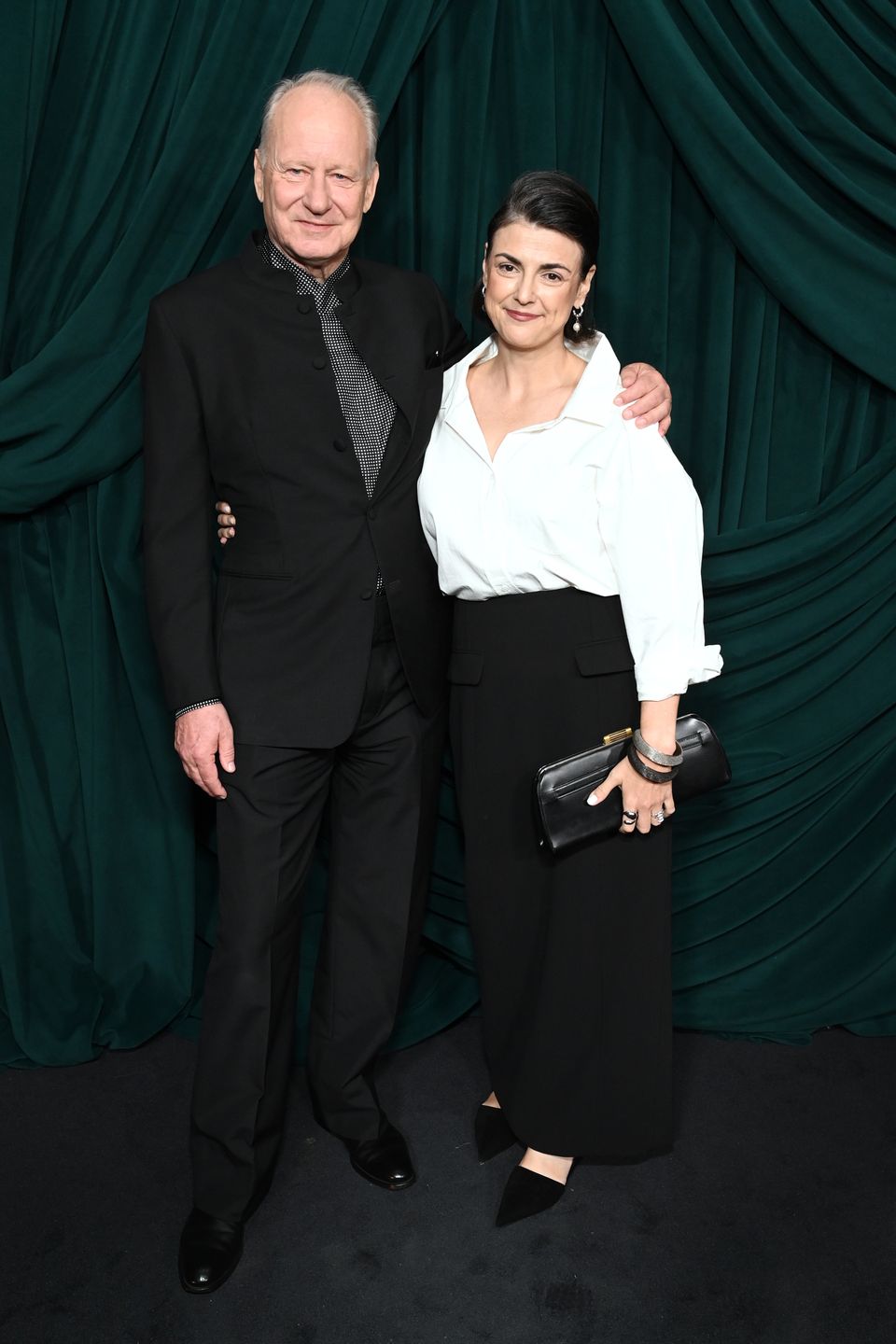 BEVERLY HILLS, CALIFORNIA - MARCH 14: (L-R) Stellan Skarsgård and Megan Everett-Skarsgård attend the CHANEL and Charles Finch Annual Pre-Oscar Dinner at the Polo Lounge at The Beverly Hills Hotel on March 14, 2026 in Beverly Hills, California.  (Photo by Jon Kopaloff/WireImage)