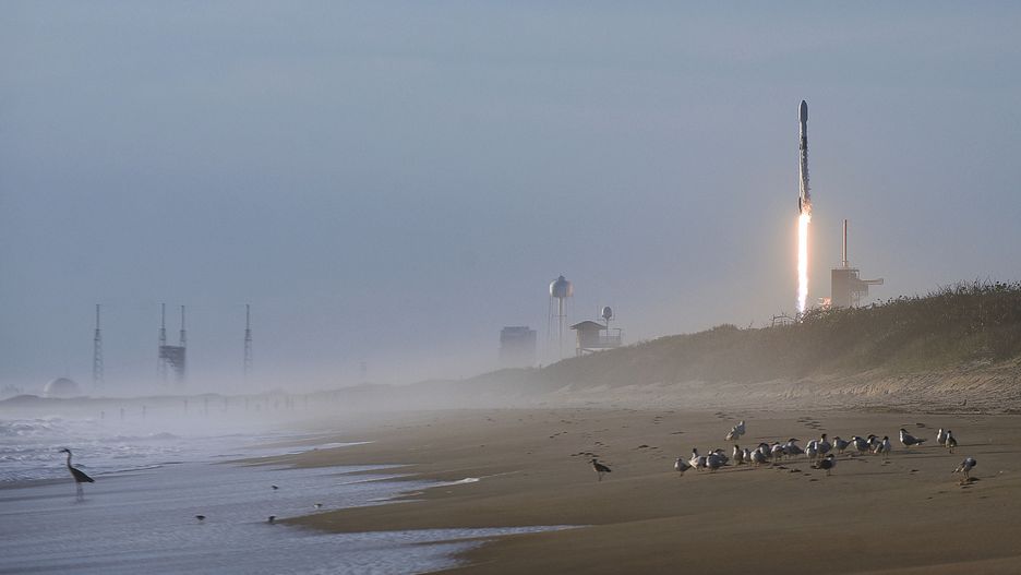 A SpaceX Falcon 9 rocket carrying 60 Starlink satellites forms a vapor cone after launching from pad 39A at the Kennedy Space Center in Florida as seen from Playalinda Beach at Canaveral National Seashore near Titusville, Florida on March 18, 2020. This is the sixth Starlink mission designed to provide global high-speed internet service.  (Photo by Paul Hennessy/NurPhoto via Getty Images)