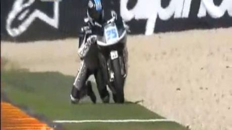 moto-gp-na-kolanach-obok-motocykla