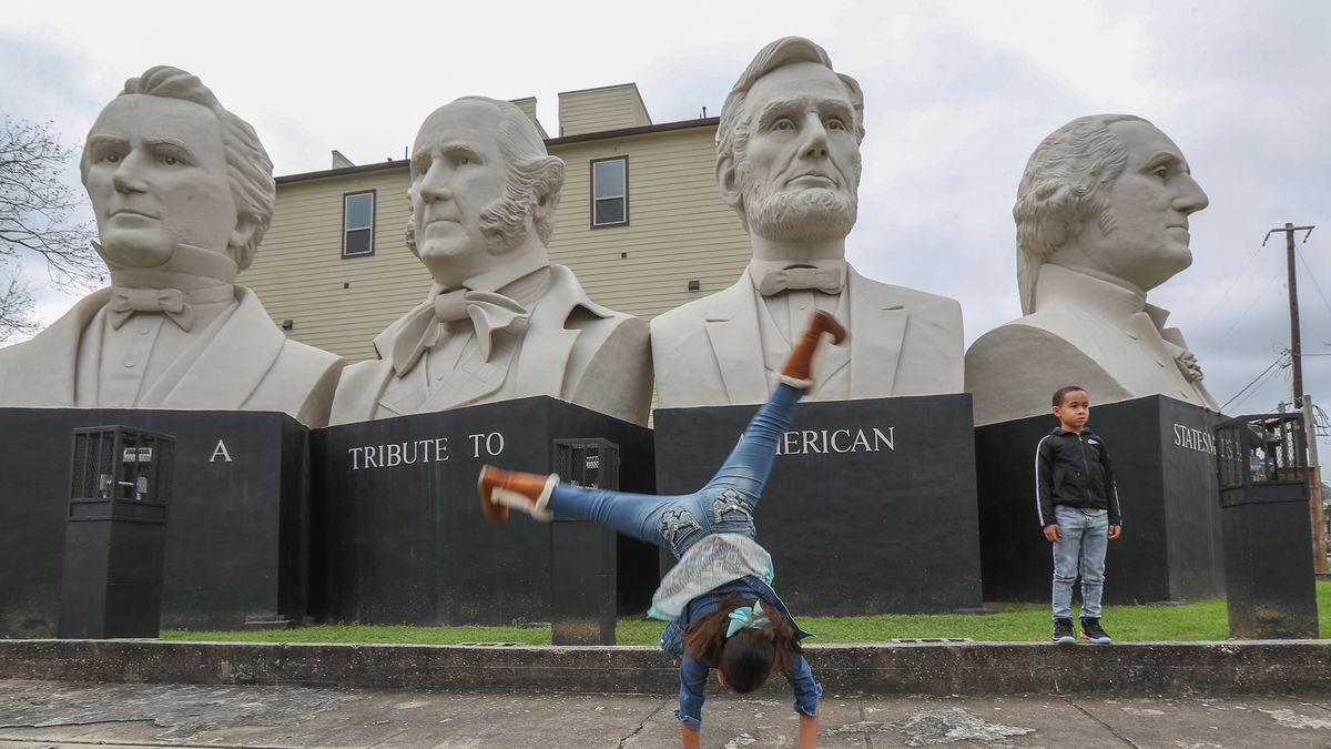 HOUSTON, TEXAS - FEBRUARY 17: Jayde Scott, 9, and her brother Ryan McIntosh, 7, have their photo taken by their father, Rudy McIntosh (not pictured), in front of artist David Adickes' 'Mount Rush Hour' in the American Statesmanship Park Sunday, Feb. 17, 2019, in Houston. The giant busts of George Washington, Abraham Lincoln, Sam Houston, and Stephen Austin are located at Elder and Bingham streets. (Steve Gonzales/Houston Chronicle via Getty Images)