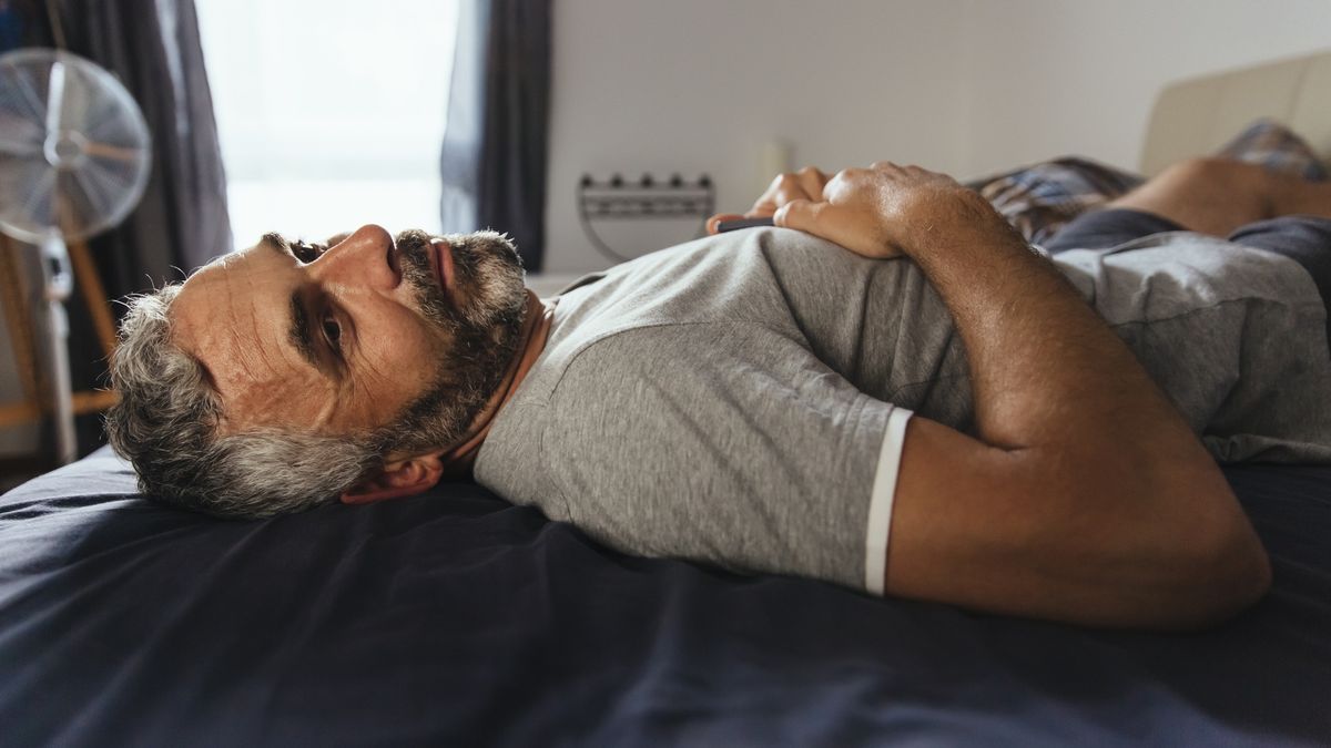 Pensive man lying on his bed at daytimeWestend61people, caucasian appearance, Adults, man, mature men, mature adult, 40-44 years, lying down, window, lying on back, Austria, thinking, indoor, day, casual clothing, relaxation, close up, contemplation, room, bedroom, home, Exhaustion, grey hair, only mature men, One Person, one mature man only, leisure, only men, one man only, side view, bed, beard, three quarter length, tired, full beard, serious, focus on foreground
