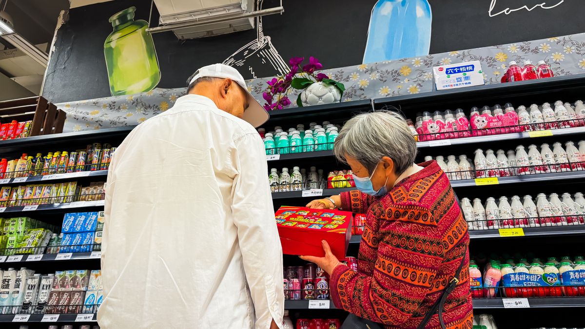 CHONGQING, CHINA - OCTOBER 20: An elderly couple examines a product in the dairy aisle of a supermarket on October 20, 2024 in Chongqing, China. The scene reflects the daily routines of senior citizens as they navigate grocery shopping in China’s urban areas. (Photo by Cheng Xin/Getty Images)