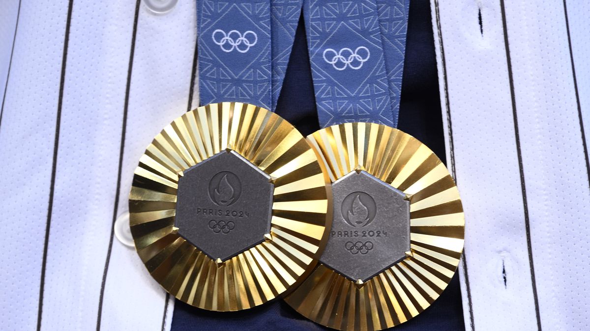 SAN DIEGO, CALIFORNIA - AUGUST 19: A detailed view of the gold medals of Cyclist Jennifer Valente from the 2024 Paris Olympics before the game between the San Diego Padres and the Minnesota Twins at Petco Park on August 19, 2024 in San Diego, California. (Photo by Orlando Ramirez/Getty Images)