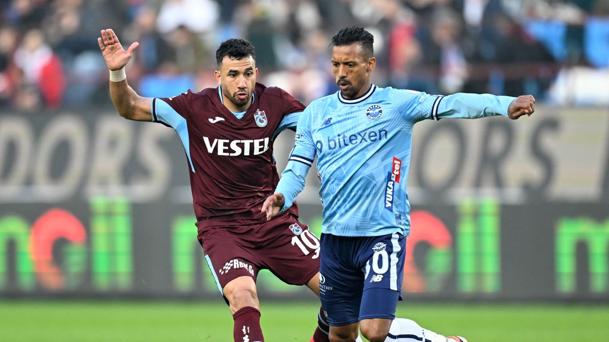TRABZON, TURKIYE - FEBRUARY 25: Mahmoud Trezeguet (L) of Trabzonspor in action against Nani of Yukatel Adana Demirspor during the Turkish Super Lig week 27 football match between Trabzonspor and Yukatel Adana Demirspor at Papara Park in Trabzon, Turkiye on February 25, 2024. (Photo by Hakan Burak Altunoz/Anadolu via Getty Images)