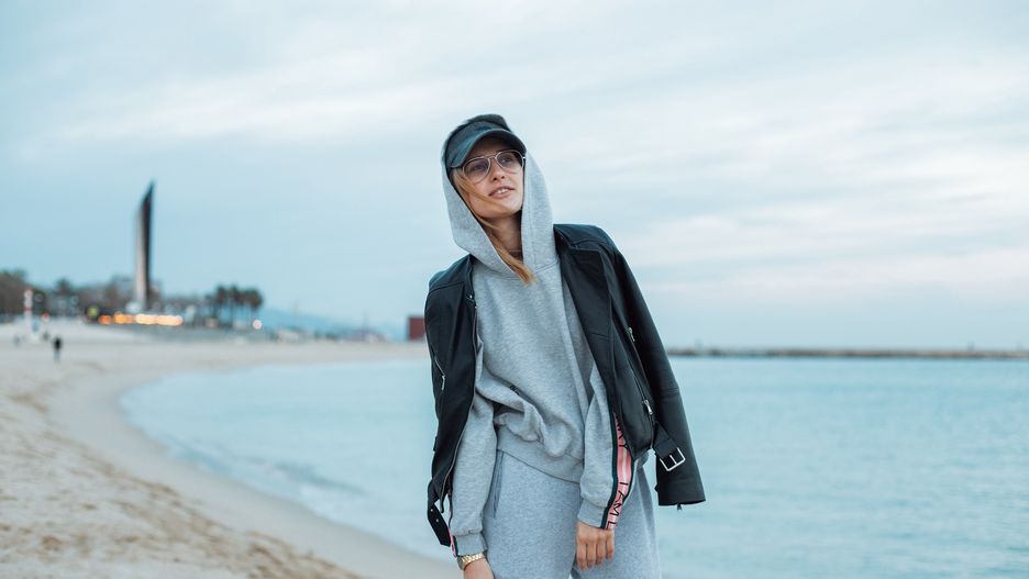 Happy and natural beauty young pretty and attractive woman or teenager wears grey hoodie and sweatpants during workout at beach seaside laughs naturally to camera, during fashion photoshoot influencerfitness,   girl,   woman,   sport,   music,   background,   person,   tracksuit,   casual,   one,   sportswear,   young,   adult,   cloudy,   concept,   confident,   cool,   exercising,   female,   fit,   clothing,   clothes,   gray,   gym,   hair,   hands,   happy,   in,   jogger,   leisure,   lifestyle,   listening,   long,   looking,   trendy,   caucasian,   outdoor,   pants,   pensive,   people,   fashion,   pockets,   portrait,   posing,   model,   pretty,   relaxation,   relaxed,   sweatpants,   runner