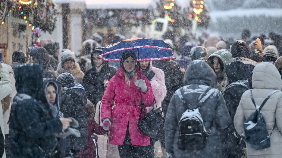 MOSCOW, RUSSIA - DECEMBER 03: People walk through snowy streets during snowfall in Moscow, Russia on December 03, 2023. (Photo by Sefa Karacan/Anadolu via Getty Images)