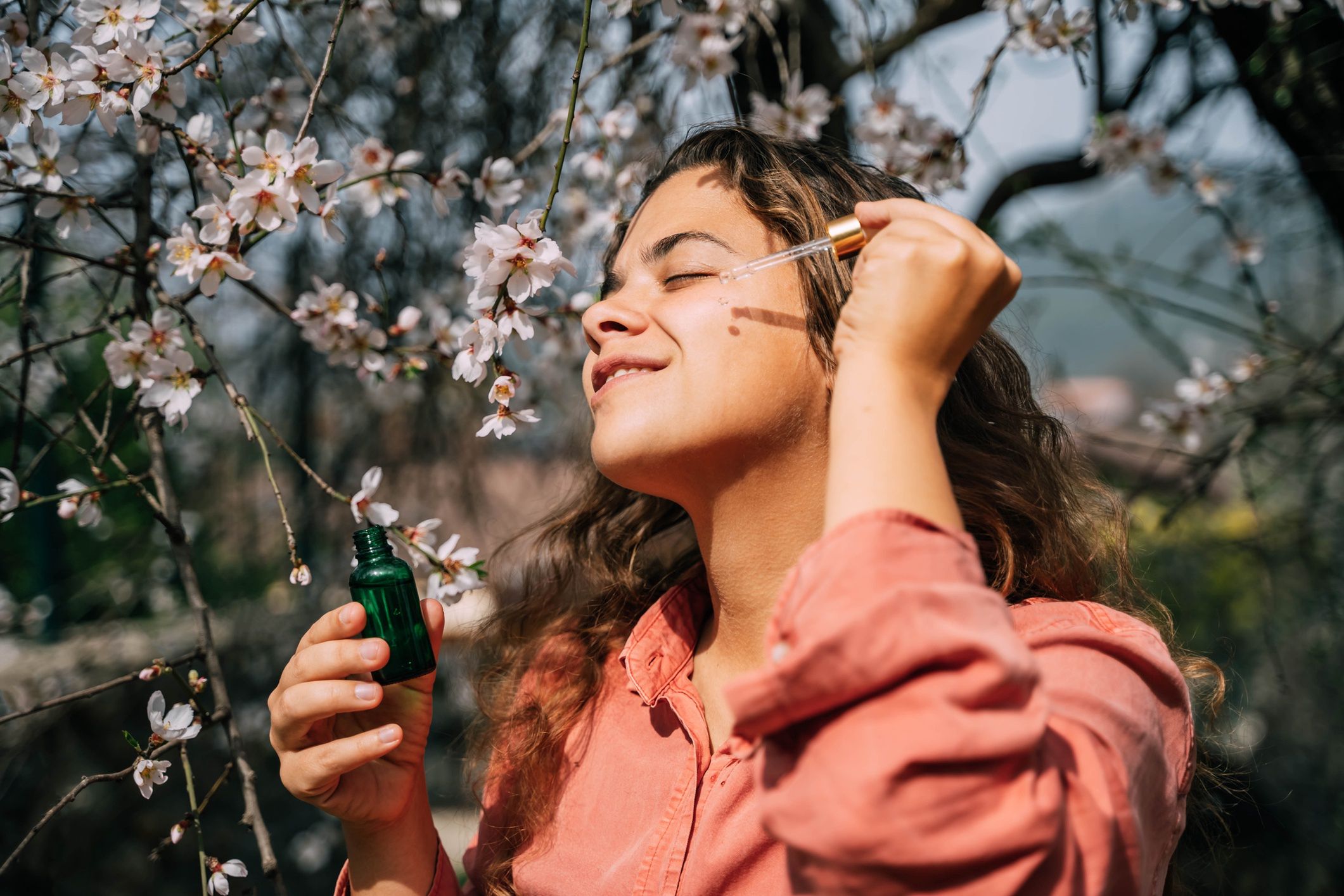A beautiful woman with clean skin drips serum from a pipette on her face.
A beautiful woman with clean skin drips serum from a pipette on her face. Sakura on background.
Tatiana Maksimova