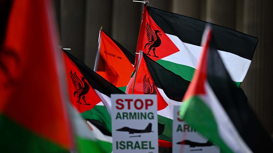 LIVERPOOL, UNITED KINGDOM - SEPTEMBER 27: Protesters wave Palestinian flags and hold placards reading "Stop starving Gaza" and "Freedom for Palestine" during a march outside St George's Plateau in Liverpool, United Kingdom on September 27, 2025, ahead of the Labour Party Conference. The demonstration, organized by the Palestine Solidarity Campaign, condemned UK government policies and called for an end to the blockade on Gaza and a halt to arms sales to Israel. (Photo by Rasid Necati Aslim/Anadolu via Getty Images)