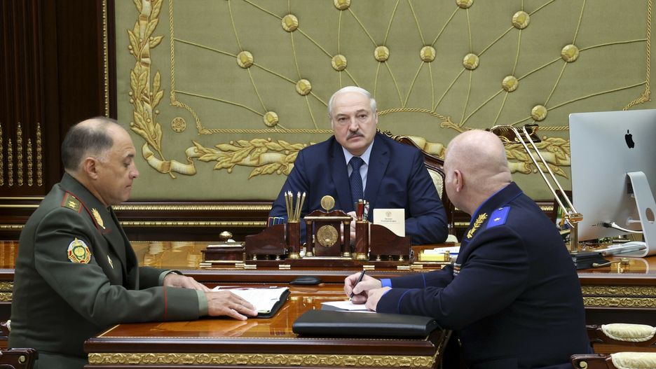 arch48Belarusian President Alexander Lukashenko, center, speaks during a meeting with the State Secretary of the Security Council Alexander Volfovich, left, and Chairman of the Investigative Committee Dmitry Gora in Minsk, Belarus, Friday, Nov. 12, 2021. (Nikolay Petrov/BelTA Pool Photo via AP)BelTA