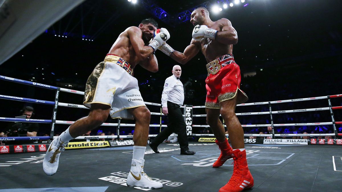 MANCHESTER, ENGLAND - FEBRUARY 19: Kell Brook (right) punches Amir Khan during their Welterweight contest at AO Arena on February 19, 2022 in Manchester, England. (Photo by Nigel Roddis/Getty Images)