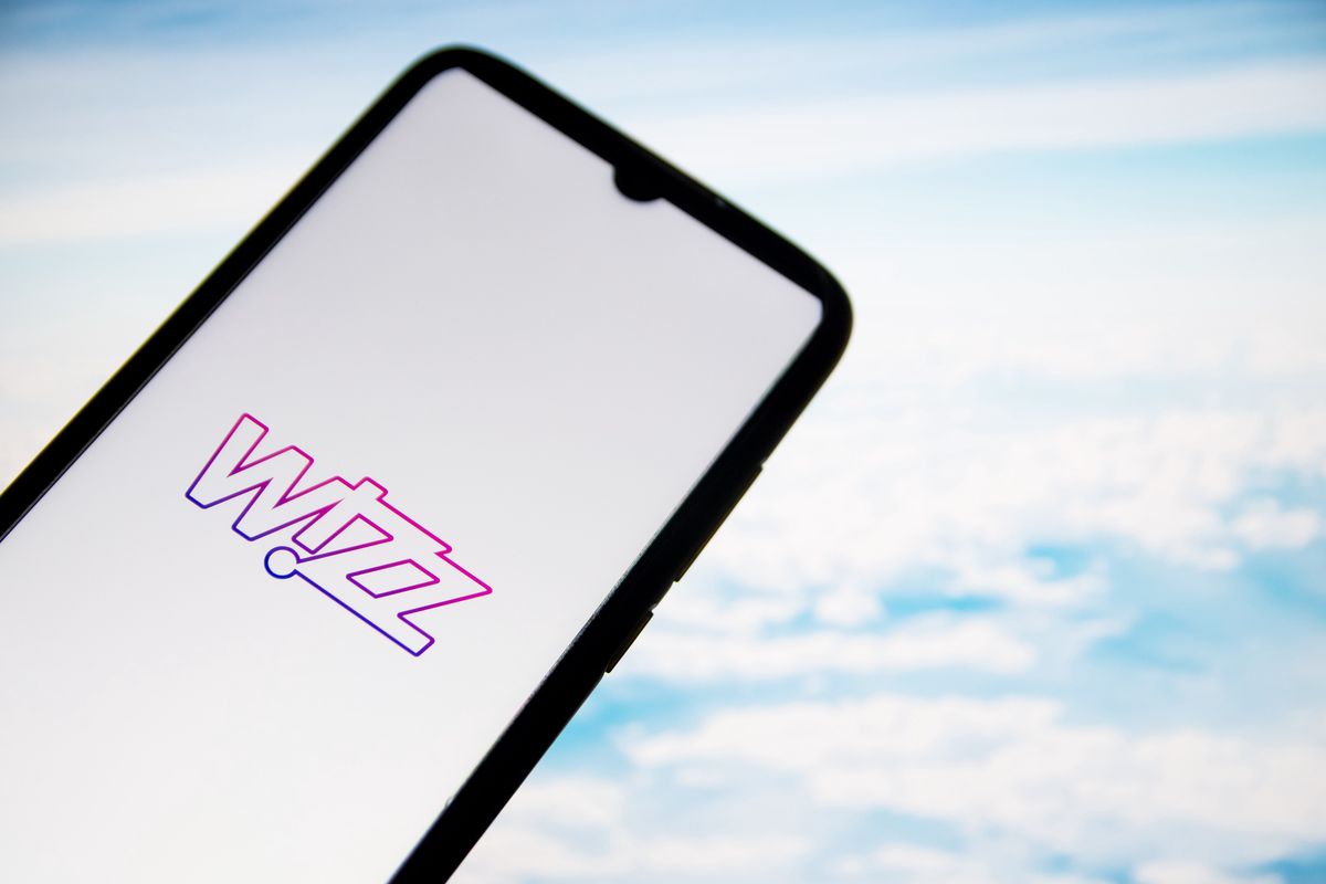 In this photo illustration a Wizz Air airlines logo seen displayed on a smartphone screen with a computer wallpaper in the background in Athens, Greece on January 27, 2022. (Photo Illustration by Nikolas Kokovlis/NurPhoto via Getty Images)