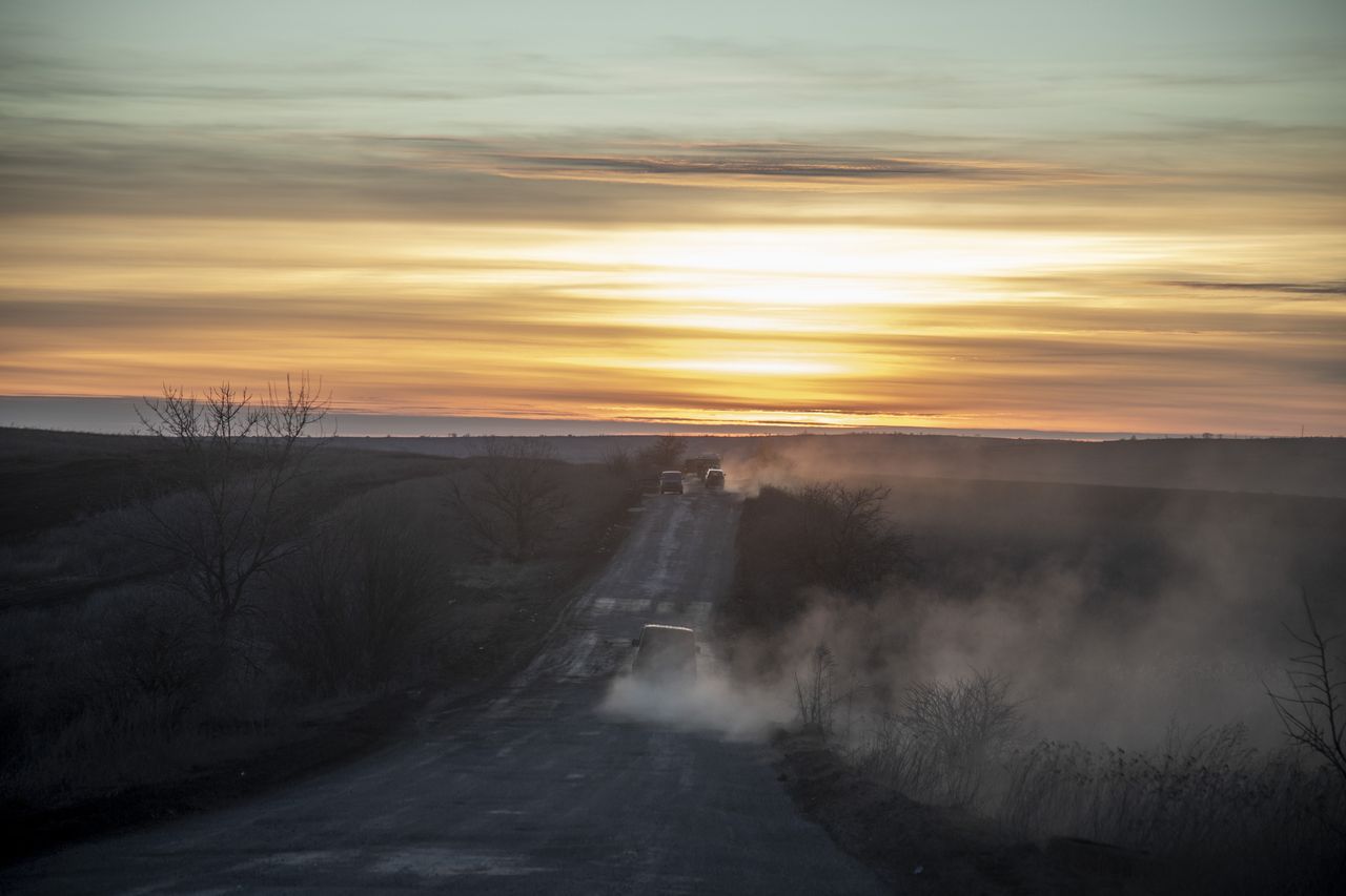 DONBAS, UKRAINE - FEBRUARY 24: Military vehicles are seen on a road at sunset on the fields nearby Chasiv Yar battlefield as fighting between Ukrainian forces and Russian troops continues on the second year anniversary of the war in Donbas, Donetsk Oblast, Ukraine on February 24, 2024. (Photo by Narciso Contreras/Anadolu via Getty Images)