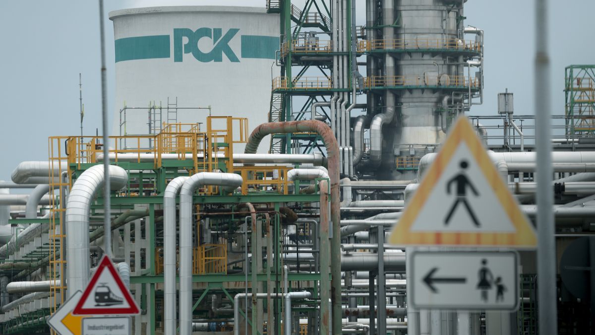 SCHWEDT, GERMANY - MAY 11: In this photograph taken through a bus window, the PCK petroleum refinery stands during a visit by German Economy and Energy Minister Katherina Reiche on May 11, 2026 in Schwedt, Germany. Reiche announced that the government is supporting a project to expand the refinery's capacity to produce electric sustainable aviation fuels (eSAF). The PCK refinery, built when eastern Germany was still part of the Soviet Bloc, received its oil through the Druzhba pipeline from Russia, though this ended with the introduction of sanctions following Russia's invasion of Ukraine. Russia recently has halted the flow of oil from Kazakhstan through the Druzhba pipeline to PCK. While the refinery receives oil through alternative means, it is producing under capacity. It is seeking government investment in refurbishing a pipeline running to the port city of Rostock and is also in talks about receiving oil through the Polish port of Gdansk. (Photo by Sean Gallup/Getty Images)