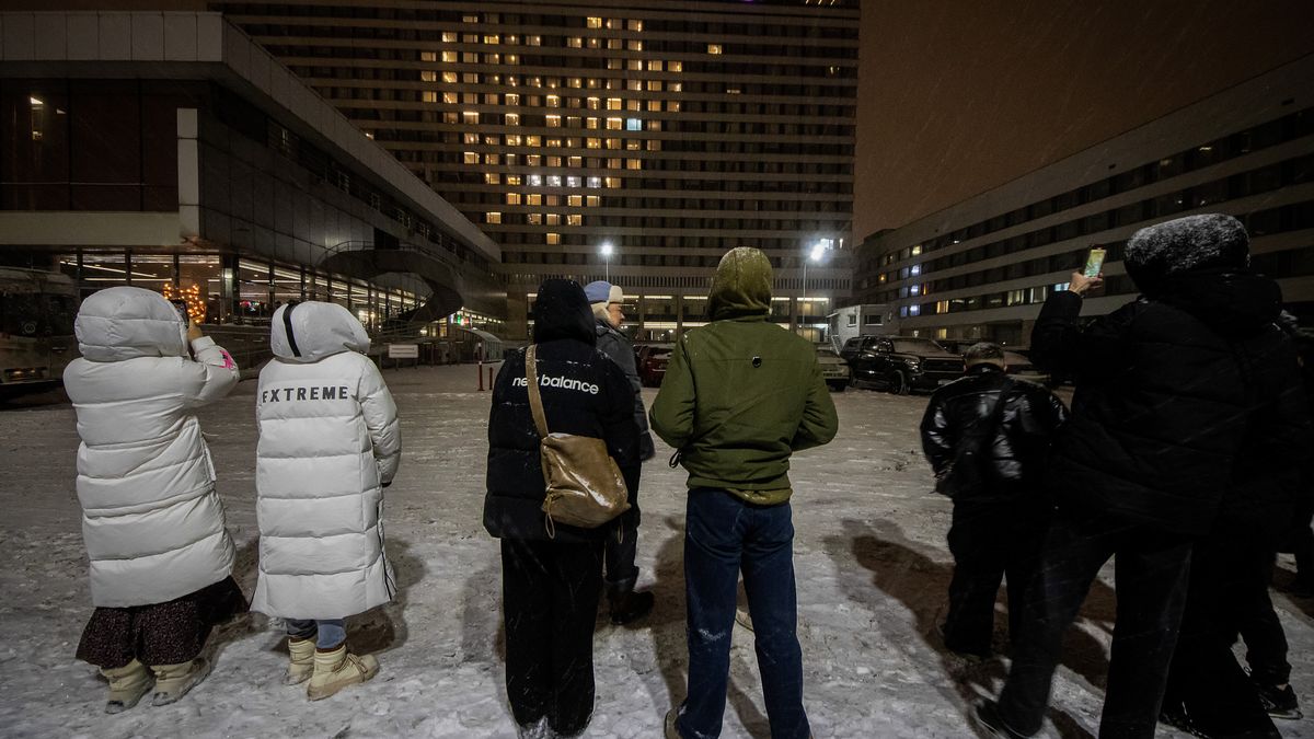 ST  PETERSBURG, RUSSIA - 2024/02/14: People gather on the street, gazing at the Azimut Hotel building adorned with a large heart-shaped illumination during the Valentine's Day celebration on February 14 in St. Petersburg. (Photo by Artem Priakhin/SOPA Images/LightRocket via Getty Images)