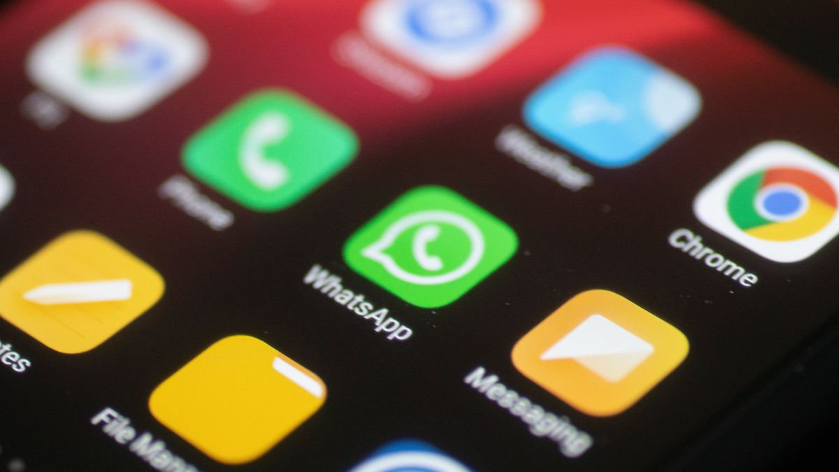 WhatsApp logo displayed on a phone screen, smartphone and keyboard are seen in this multiple exposure illustration. WhatsApp Messenger is a multiplatform mobile application that provides an encrypted instant messaging system belonging to Facebook, photo taken in Amsterdam, Netherlands on January 28, 2020 (Photo illustration by Nicolas Economou/NurPhoto via Getty Images)