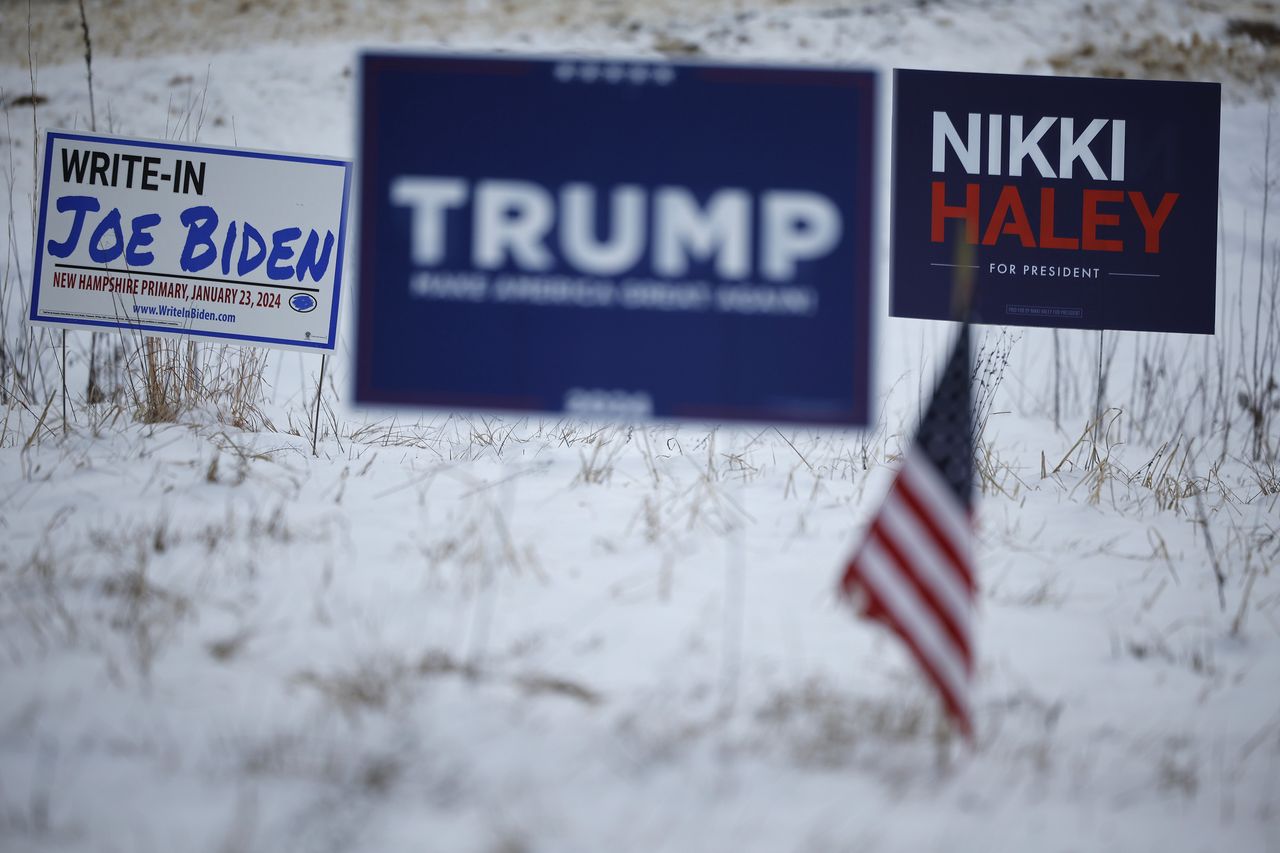 LOUDON, NEW HAMPSHIRE - JANUARY 19: Campaign signs for Republican presidential candidates former President Donald Trump and former UN Ambassador Nikki Haley stand next to a sign asking voters to write in President Joe Biden in next Tuesday's primary election on January 19, 2024 in Loudon, New Hampshire. New Hampshire voters will weigh in next week on the Republican nominating race with their first-in-the-nation primary, about one week after Trump's record-setting win in the Iowa caucuses. Haley is hoping for a strong second-place showing so to continue her campaign into Nevada and South Carolina. (Photo by Chip Somodevilla/Getty Images)