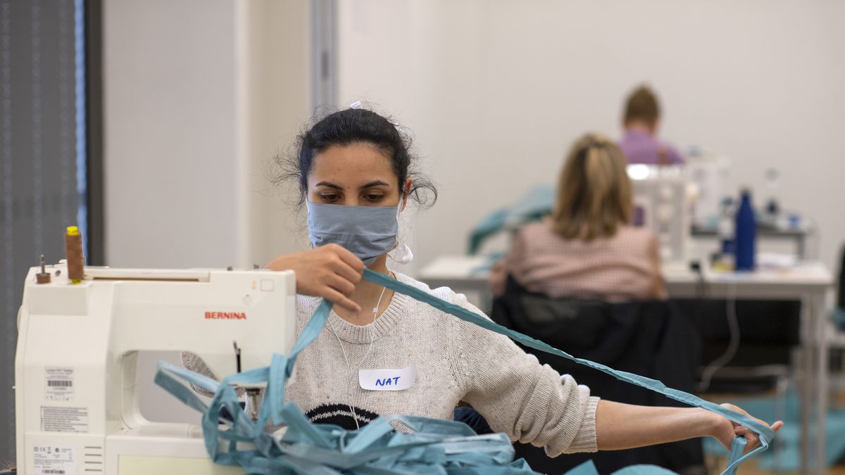 LONDON, ENGLAND - MAY 01: A volunteer manufactures surgical gowns, made from operating theatre drapes, for The Royal Free Hospital at Kensington and Chelsea College on May 01, 2020 in London, England.  The surgical gowns are designed to go straight from sewing machine and on to a health worker’s back in a Covid 19 ward, in a matter of hours.  The project set up by Fashion School Director, Caroline Gration, whose daughter Dr Betty Gration has been heading a Covid 19 ward at The Royal Free Hospital in Hampstead,  had an initial aim of producing 500 gowns a day, but has recently managed 705 in one day and has so far produced 6’461 gowns. (Photo by Justin Setterfield/Getty Images)