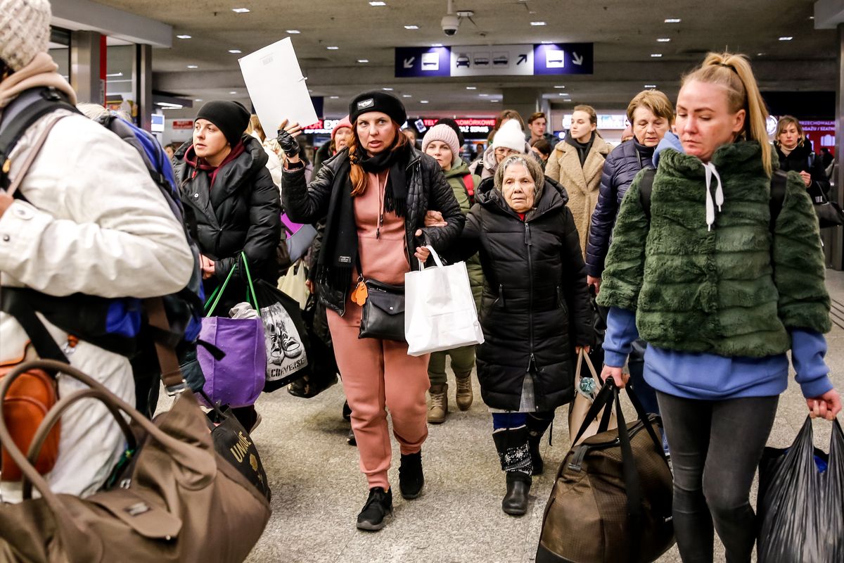 A Ukrainian woman, Olga Oszal from Abdar travel agency leads a group of Ukrainian refugees she drove to Krakow from Lviv as part of her humanitarian effort for Ukraine as more than two million people have fled Ukraine for Poland, April 5, 2022. As the Russian Federation invaded Ukraine, the conflict is expected to force up to 5 million Ukrainians to flee the country. Many of the refugees seek asylum in Poland. Most charitable help in Poland is provided by individuals, NGOs and businesses. Abdar travel agency is a business run by mixed marriage - Ukrainian Olga and Polish Maciej Oszal.  Since the beginning of the conflict the couple drives a coach to Lviv to deliver humanitarian aid goods and to bring refugees from the western Ukrainian city. (Photo by Dominika Zarzycka/NurPhoto via Getty Images)