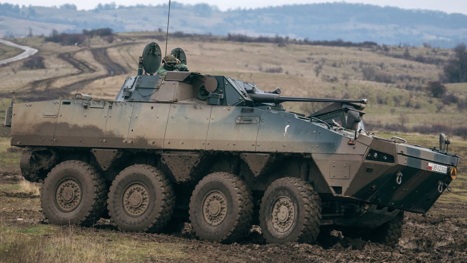 Polish soldiers in a KTO Rosomak armored personnel carrier participate in the Black Scorpions NATO 22.8 live-fire military exercise at the Getica National Joint Training Center in Cincu, Romania, on Friday, Nov. 25, 2022. Following Russia's attack on Ukraine, NATO allies have significantly bulked up their presence at the alliance's eastern borders, deploying more troops, jets and ships. Photographer: Andrei Pungovschi/Bloomberg via Getty Images