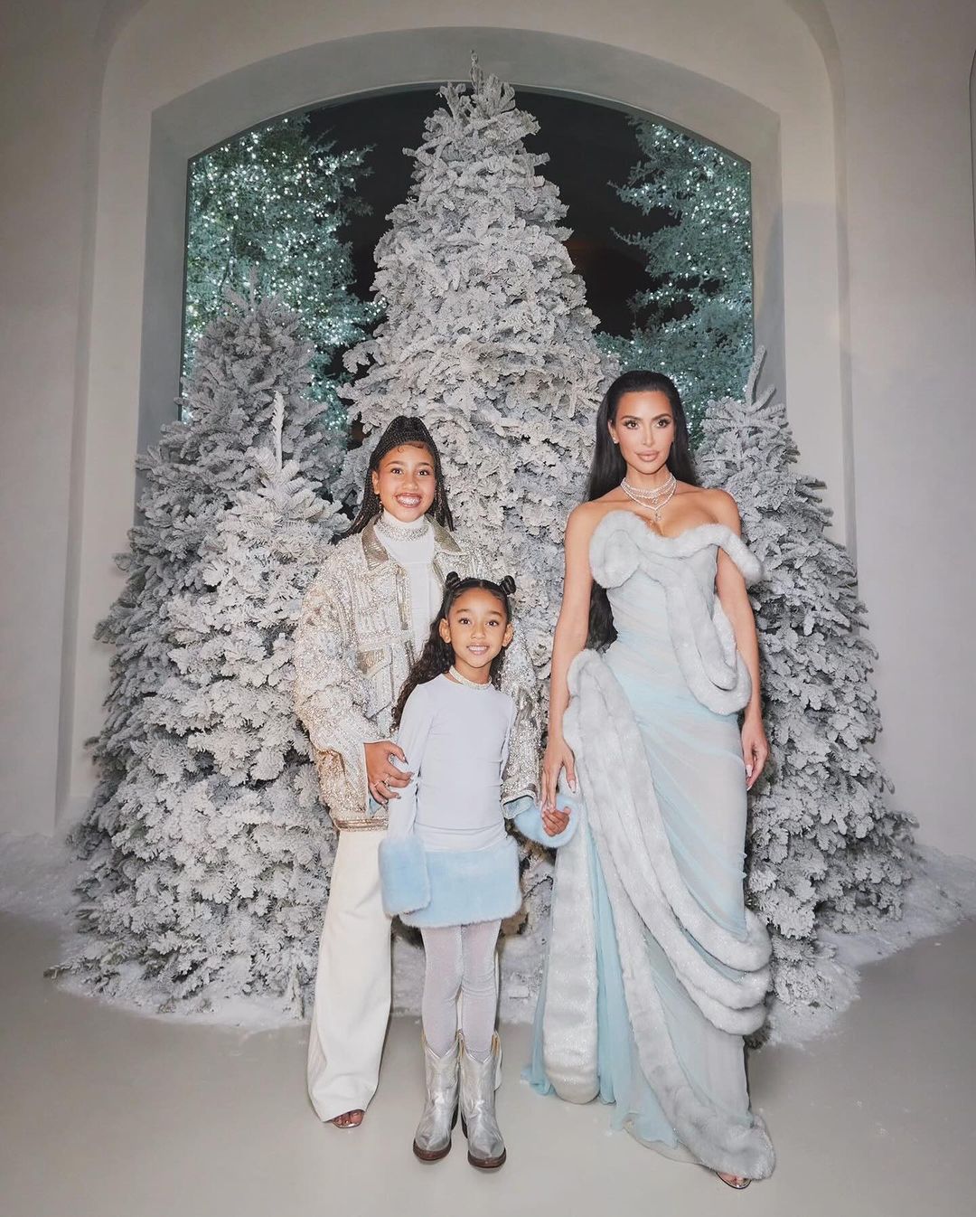 Kim Kardashian with children at a holiday party