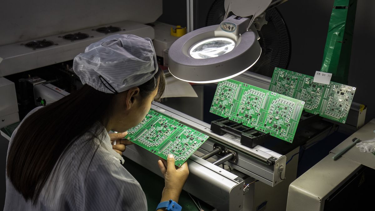 An employee inspect integrated circuit boards at the Smart Pioneer Electronics Co. factory in Suzhou, China, on Friday, Sept. 23, 2022. In a world where chips are becoming smarter and smaller, they require much less advanced technology to manufacture and therefore command smaller margins. Photographer: Qilai Shen/Bloomberg via Getty Images