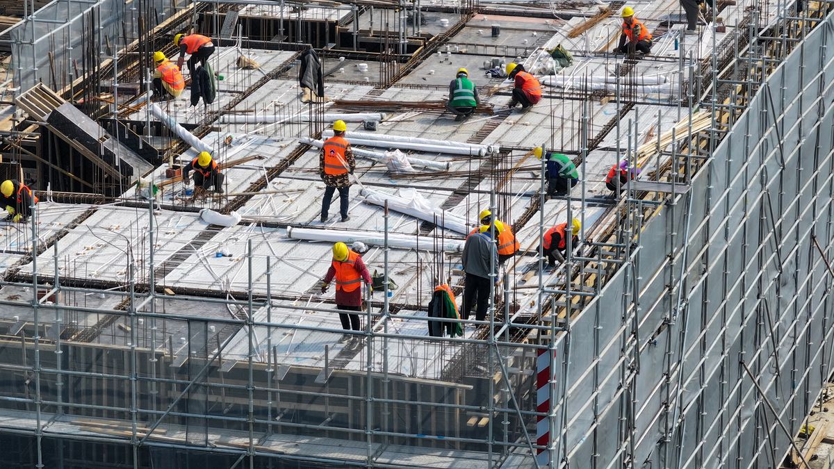 Workers are working at a commercial housing site under construction in Nanjing, Jiangsu Province, China, on March 7, 2024. (Photo by Costfoto/NurPhoto via Getty Images)